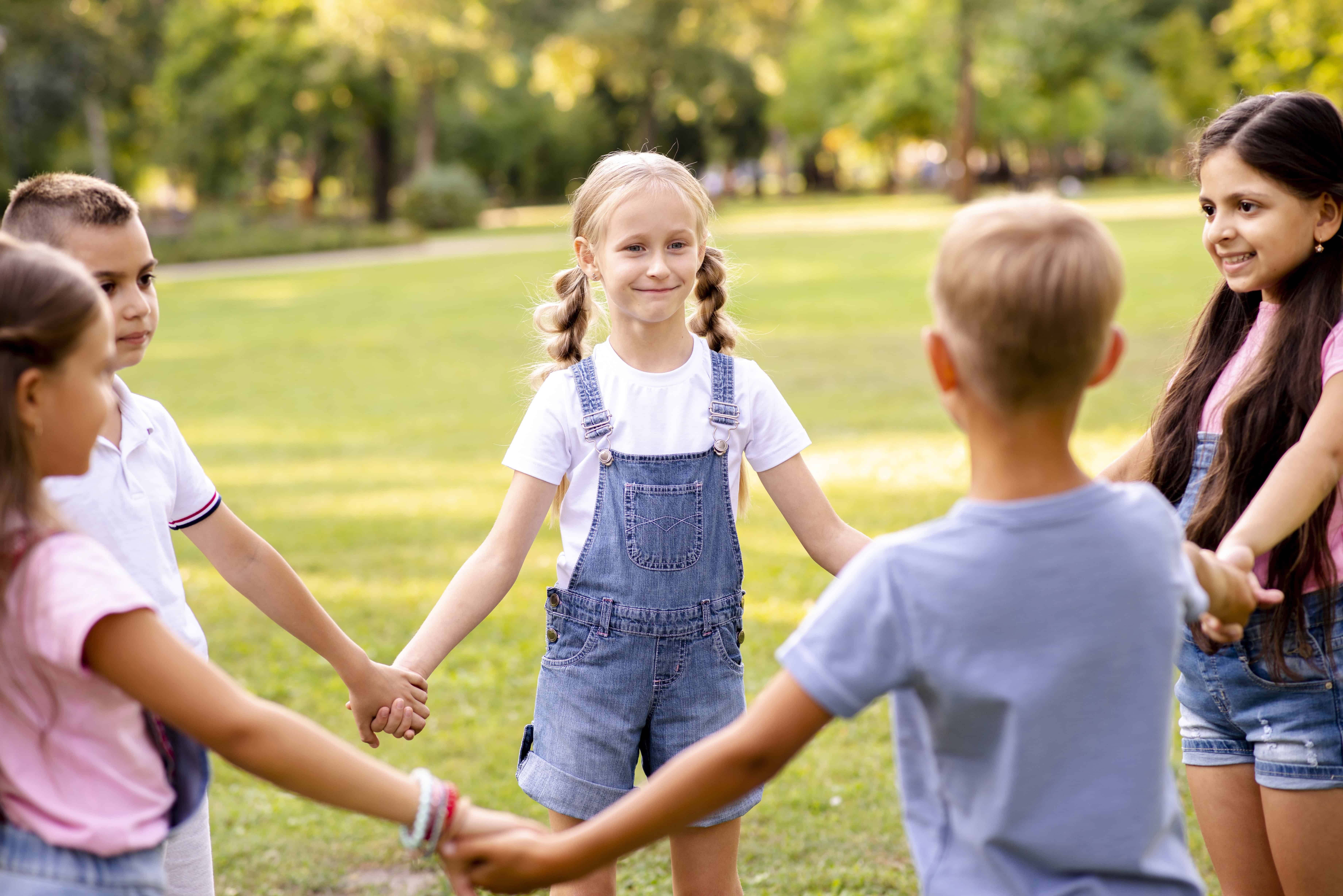 five children forming circle together